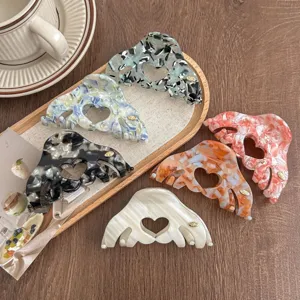 Korean minimalist acetate hair claw clip with hollow heart design, elegant styling accessory.