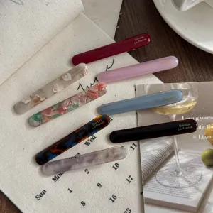 Detailed close-up of minimalist acrylic hair barrettes showing premium texture and colors.