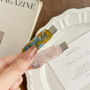 Korean style tortoiseshell acetate hair clip detail shot, elegant side duckbill clip for bangs.