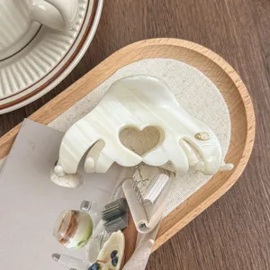 Korean minimalist acetate hair claw clip with a hollow heart design for elegant daily hairstyles.