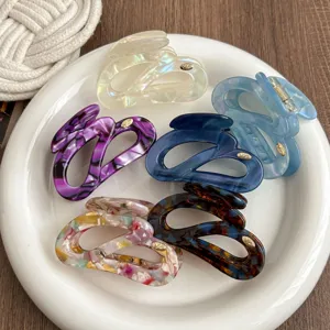 Details view of stylish irregular hair claws, multi-color acrylic shark clips for women.