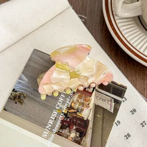 Medium acetate hair claw clip with elegant pink and white marbled pattern for daily styling.
