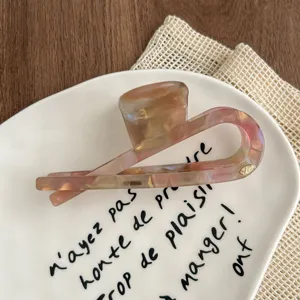 Detailed close-up of the elegant translucent fish tail hair claw clip, showcasing smooth polish.