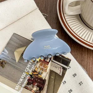 Elegant blue acetate hair claw clip for women, stylish medium size ponytail clamp accessory.