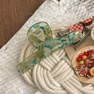 Korean acetate hair claw clip with unique green marble pattern, elegant daily styling detail