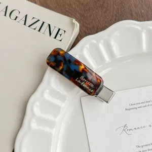 Korean style tortoise shell acrylic hair clip detail shot showing metallic duckbill clip and print.