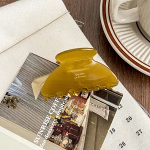 Amber acetate hair claw clip, detailed view of the elegant medium shark clip for women.