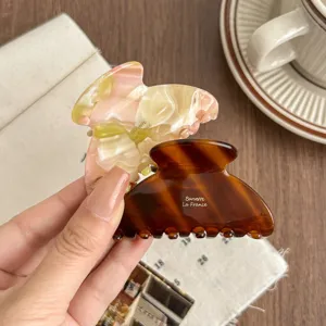 Elegant medium acetate hair claw clip set, tortoiseshell and pink marble design for women.