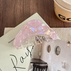 Close-up detail of the pink iridescent hair claw clip, stylish acetate texture for daily updos.