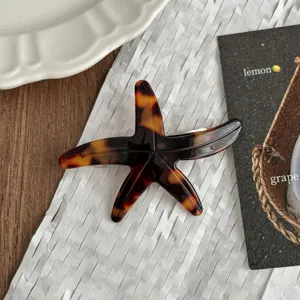 Detailed view of a chic tortoise shell starfish hair clip, stylish acetate side hairpin for women.