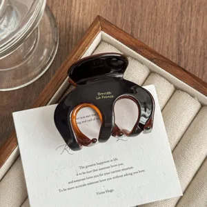 Medium tortoise acetate hair claw clip, elegant design for thin hair and daily styling.