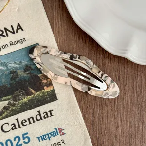 Detail view of stylish marble pattern hair clip, elegant bobby pin for daily casual wear.
