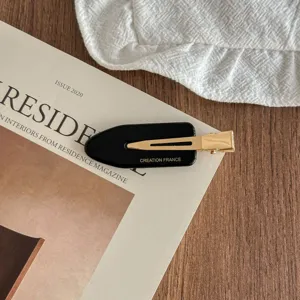 Exquisite black acetate side hair clip with gold metal duckbill design for elegant daily styling.