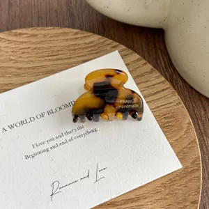 Small tortoiseshell hair claw clip acrylic mini hair accessory for women daily styling.
