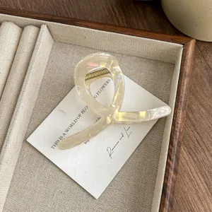 Detail view of the elegant iridescent hair claw clip featuring a unique abstract design.