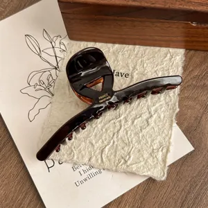 Elegant dark brown acetate hair claw clip for women, stylish shark clip for daily hair styling.