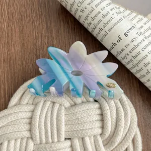Detail view of large blue purple gradient acetate flower hair claw clip, chic daily styling.
