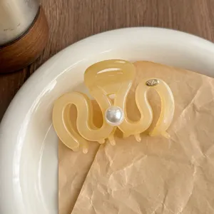 Elegant Maillard hair claw clip for women, medium translucent resin shark clip with pearl detail.