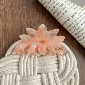 Close-up of a large pink acetate flower hair claw clip, elegant and fresh hair accessory design.