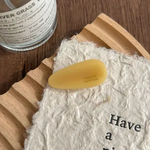 Acetic acid teardrop hair clip detail view, amber yellow minimalist side bangs pin.