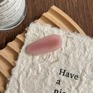 Close up detail of pink water drop acetate hair clip, cute side bang hairpin for women.