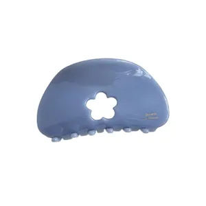 Chic blue acetate hair claw clip with cute hollow flower design for daily elegant styling.
