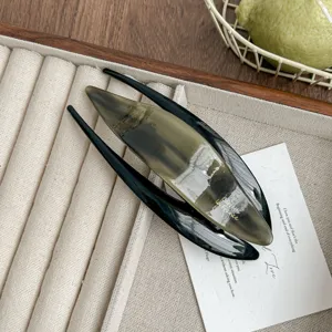 Exquisite acetate hair clip detail showing smooth gradient color and elegant swallowtail design.