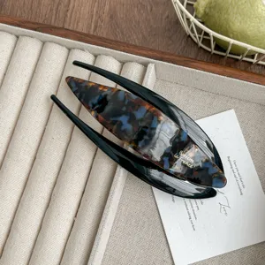Elegant tortoiseshell acetate swallowtail hair clip detail, stylish French barrette for women.