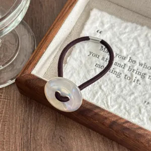 Retro iridescent button hair tie with dark brown elastic band. Elegant and stylish hair accessory.