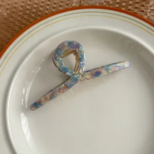 Acetate hair claw clip for women, unique geometric design shark clip, elegant hair accessory detail view.