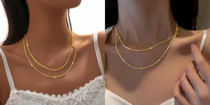 Close-up detailopname van een dubbellaags glanzende gouden sleutelbeinketting ketting, schitterend.
