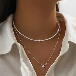 Elegant double layer silver necklace with sparkly chain and minimalist cross pendant for women.