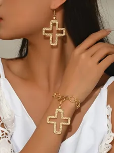Gold-tone hollow cross pendant earrings and chain bracelet set, detailed textured design.