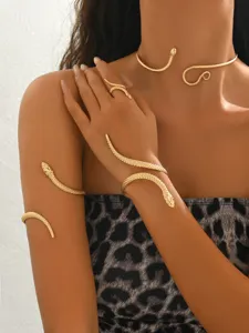 Elegant gold snake jewelry set featuring choker, arm cuff, bracelet and ring for women.