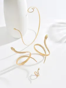 Close-up detail shot of exquisite gold snake jewelry set, including choker, bracelets and ring.