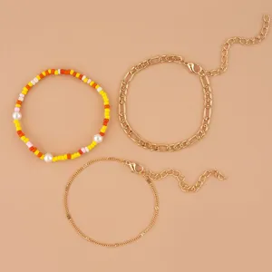 Fashion 3-piece bracelet set featuring colorful beading, pearl accents, and elegant gold chains.