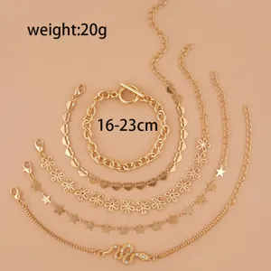 Set of 5 gold-layered bracelets featuring snake, star, clover, and heart charms for women.