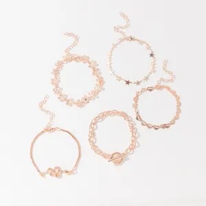 Detailed view of the 5-piece rose gold bracelet set featuring cute charms and chains.