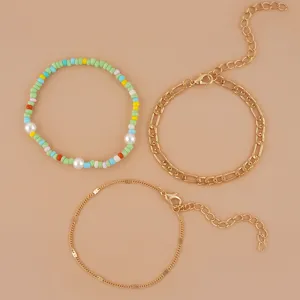 Trendy 3-piece bracelet set featuring colorful seed beads, pearls, and classic gold chains.