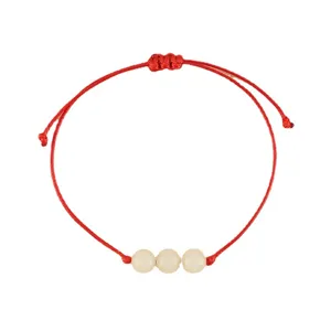 Handmade red string woven bracelet featuring three luminous beads for women daily fashion wear.
