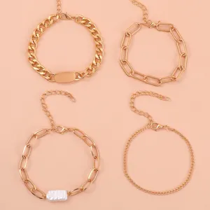 Detail view of a stylish 4-piece gold chain bracelet set featuring faux pearls and link chains.
