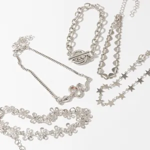 5-piece silver tone bracelet set featuring snake heart star and floral chain designs.