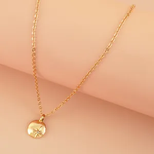 Delicate gold-tone necklace featuring a sparkling eight-pointed star pendant and fine chain.