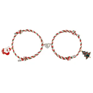 Christmas magnetic couple bracelet set with Santa Claus and tree charms for holiday gifts.