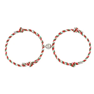 Close-up detail of Christmas magnetic rope bracelet, red green white braided couple jewelry.