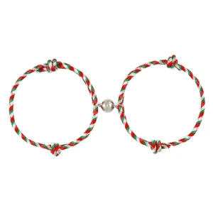Close-up of Christmas magnetic couple bracelet with red green white braided rope and clasp.