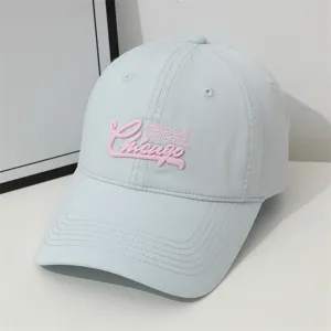 Light blue baseball cap detail, pink Chicago embroidery, casual cotton sun hat close-up.