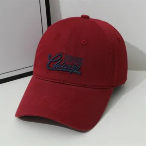 Red baseball cap detail, vintage Chicago embroidered lettering, soft top casual hat close up.