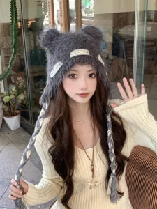 Cute fuzzy knit beanie hat with bear ears and braided straps, warm winter fashion for women.