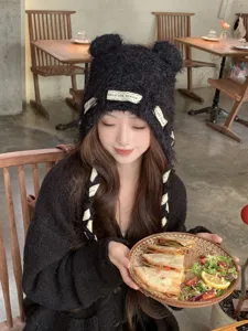 Cozy black knit beanie hat with cute bear ears and stylish ribbon text for women autumn.